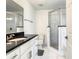Modern bathroom with marble floors, a glass-enclosed shower, and a vanity with a dark countertop at 438 Jay Ct, Kissimmee, FL 34759