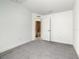 This bedroom has neutral colored carpet and an attached bathroom with tile flooring at 438 Jay Ct, Kissimmee, FL 34759