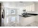 Bright kitchen with white cabinetry, stainless steel appliances, and a seamless transition into the dining area at 438 Jay Ct, Kissimmee, FL 34759