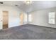 Spacious main bedroom with two windows, neutral carpet, and access to a walk-in closet and bathroom at 438 Jay Ct, Kissimmee, FL 34759