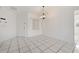 Simple dining area with tile floors and a chandelier at 511 Cardinal Dr, Kissimmee, FL 34759