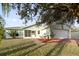 Front view of a single-story house with a garage and landscaping at 511 Cardinal Dr, Kissimmee, FL 34759