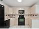 Galley style kitchen with black appliances and wood cabinets at 511 Cardinal Dr, Kissimmee, FL 34759
