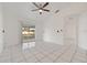 Living room with tile floors, sliding glass doors, and a ceiling fan at 511 Cardinal Dr, Kissimmee, FL 34759