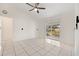 Living room with tile floors, sliding glass doors, and a ceiling fan at 511 Cardinal Dr, Kissimmee, FL 34759