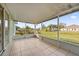 Screened patio with tile flooring, offering backyard views at 511 Cardinal Dr, Kissimmee, FL 34759