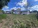 Large backyard with a small home in the background, offering ample space for outdoor activities at 589 Duncan E Cir, Auburndale, FL 33823