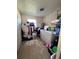 Messy laundry room with a washer, dryer, and lots of clutter at 589 Duncan E Cir, Auburndale, FL 33823