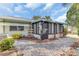 Backyard with a screened sunroom and a gravel pathway at 713 Lake Dexter Cir, Winter Haven, FL 33884