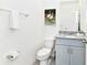Small bathroom with toilet and granite vanity at 7638 Oakmoss Loop, Davenport, FL 33837