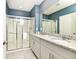 Bathroom with granite vanity and shower at 7638 Oakmoss Loop, Davenport, FL 33837