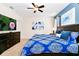 Bedroom with king bed and blue bedding at 7638 Oakmoss Loop, Davenport, FL 33837