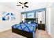 Spacious bedroom with king bed and blue bedding at 7638 Oakmoss Loop, Davenport, FL 33837
