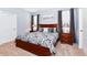 Large bedroom with a wooden bed frame and light gray walls at 7638 Oakmoss Loop, Davenport, FL 33837