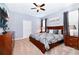 Bright bedroom with a king-size bed and wood furniture at 7638 Oakmoss Loop, Davenport, FL 33837