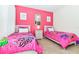 Bright bedroom with twin beds and pink accents at 7638 Oakmoss Loop, Davenport, FL 33837
