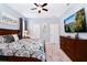 Bright bedroom featuring a king-size bed and large TV at 7638 Oakmoss Loop, Davenport, FL 33837
