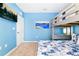 Blue-walled bedroom with bunk bed and ocean art at 7638 Oakmoss Loop, Davenport, FL 33837