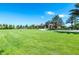 Expansive grassy area with a community building and palm trees at 7638 Oakmoss Loop, Davenport, FL 33837