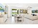 Dining area with a rustic table and chairs, open to the living room at 7638 Oakmoss Loop, Davenport, FL 33837