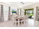 Elegant dining area with a table for six and access to the pool at 7638 Oakmoss Loop, Davenport, FL 33837