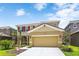 Two-story house with attached garage and landscaping at 7638 Oakmoss Loop, Davenport, FL 33837