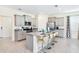 Modern kitchen with gray cabinets, granite countertops, and stainless steel appliances at 7638 Oakmoss Loop, Davenport, FL 33837