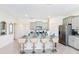 Open kitchen features granite island with seating, gray cabinets, and stainless steel appliances at 7638 Oakmoss Loop, Davenport, FL 33837