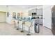Modern kitchen with gray cabinets, granite countertops, and stainless steel appliances at 7638 Oakmoss Loop, Davenport, FL 33837