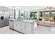 Open kitchen with large island, stainless steel appliances, and gray cabinets at 7638 Oakmoss Loop, Davenport, FL 33837