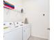 Convenient laundry room with washer, dryer, and shelving at 7638 Oakmoss Loop, Davenport, FL 33837