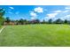 Expansive green lawn with community center in background at 7638 Oakmoss Loop, Davenport, FL 33837