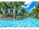 Serene lazy river pool surrounded by palm trees at 7638 Oakmoss Loop, Davenport, FL 33837
