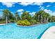 Tranquil lazy river pool with lush landscaping at 7638 Oakmoss Loop, Davenport, FL 33837