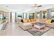 Spacious living room with beige sectional sofa and colorful rug at 7638 Oakmoss Loop, Davenport, FL 33837