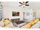 Open living space with sectional sofa, coffee table, and large TV at 7638 Oakmoss Loop, Davenport, FL 33837