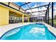 Relaxing pool and spa with screened enclosure at 7638 Oakmoss Loop, Davenport, FL 33837