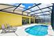 Pool and spa with screened patio and lounge chairs at 7638 Oakmoss Loop, Davenport, FL 33837