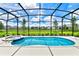 Relaxing pool and spa area with screened enclosure at 7638 Oakmoss Loop, Davenport, FL 33837