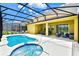 Inviting pool and spa with covered patio; perfect for relaxation at 7638 Oakmoss Loop, Davenport, FL 33837