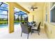 Covered patio with pool table and outdoor dining at 7638 Oakmoss Loop, Davenport, FL 33837