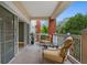 Relaxing balcony with seating for two and treetop views at 7658 Whisper Way # 202, Reunion, FL 34747