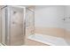 Bathroom features a walk-in shower and a separate tub at 7658 Whisper Way # 202, Reunion, FL 34747
