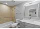 Well-lit bathroom featuring a tub, shower, and vanity with a large mirror at 7658 Whisper Way # 202, Reunion, FL 34747