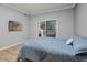 Cozy bedroom with a mounted TV and sliding door access to the balcony at 7658 Whisper Way # 202, Reunion, FL 34747