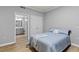 Serene bedroom featuring wood floors, a full bath, and a double door closet at 7658 Whisper Way # 202, Reunion, FL 34747