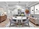 Open-concept dining room features modern lighting and a round table, perfect for entertaining at 7658 Whisper Way # 202, Reunion, FL 34747