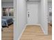 Hallway features wood flooring, a front door, and glimpses into the bedrooms at 7658 Whisper Way # 202, Reunion, FL 34747