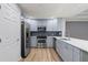 Stylish kitchen with stainless steel appliances, light blue cabinets, and attractive backsplash at 7658 Whisper Way # 202, Reunion, FL 34747