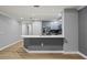 Modern kitchen with light gray cabinets, stainless steel appliances, and a breakfast bar at 7658 Whisper Way # 202, Reunion, FL 34747